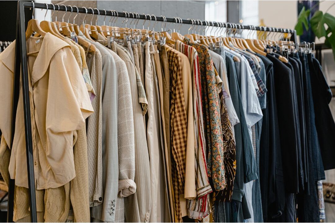 neatly arranged women linen loungewear hanging on wooden rack
