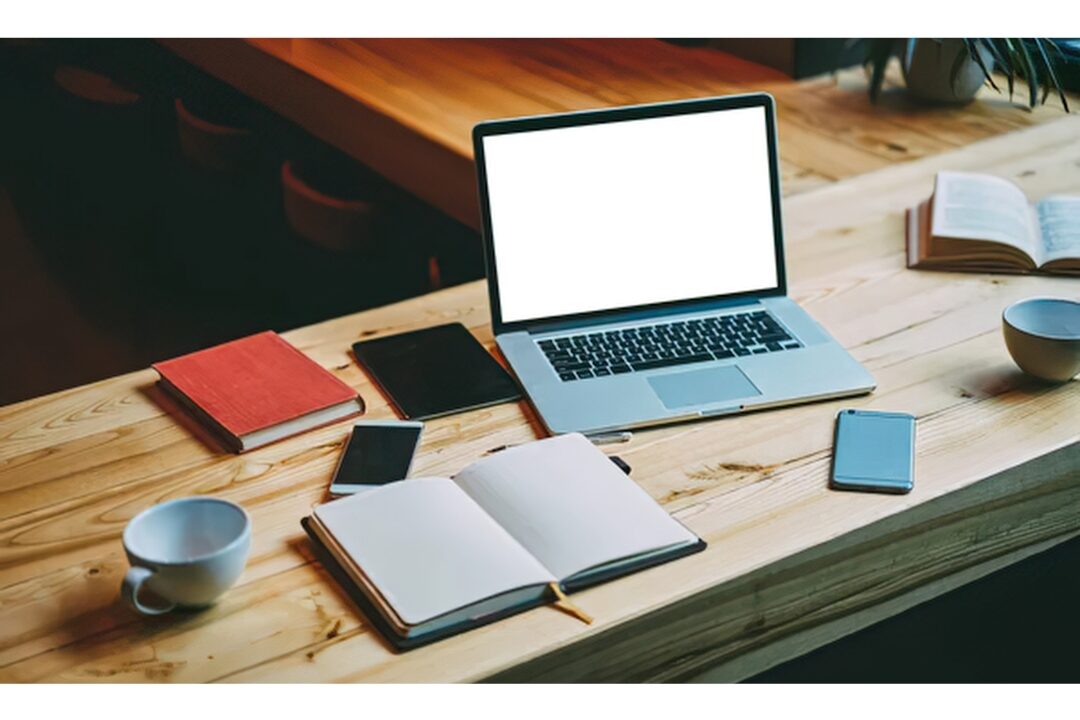 laptop open on wooden desk displaying cloud folders review 50 things to stop buying to save money