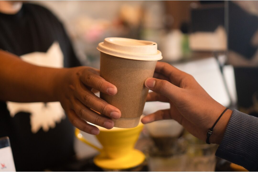 cozy coffee shop takeaway cup representing 50 things to stop buying to save money