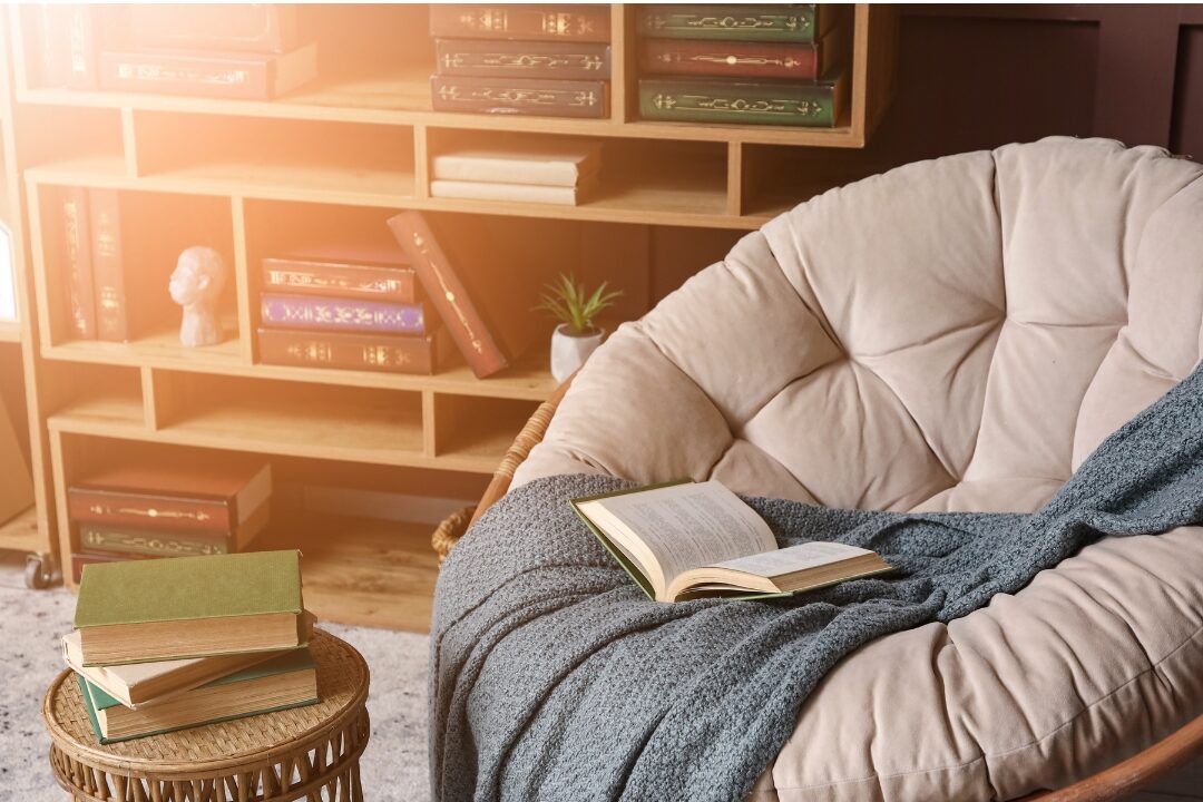 cozy reading corner with an upholstered armchair warm lamp and bookshelf