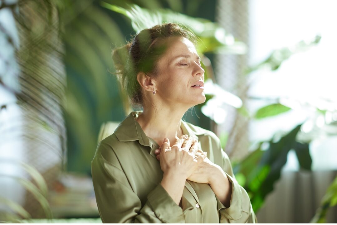 serene woman taking a quiet deep breath with closed eyes cultivating emotional regulation