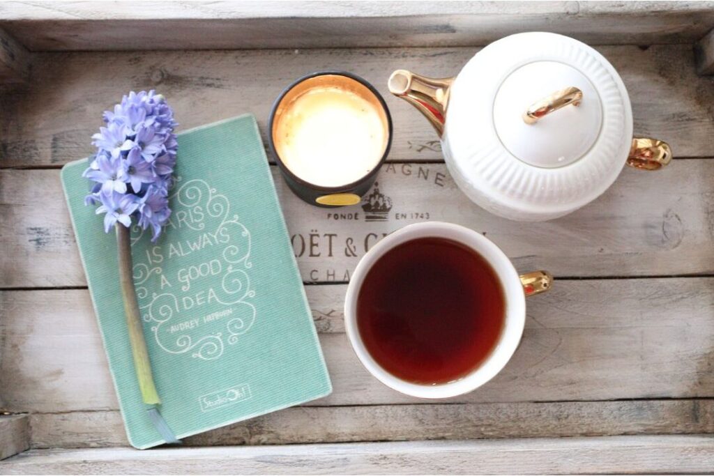 herbal tea and fresh flowers on tray illustrating daily self-care rituals from the soft life checklist i wish every mom had before having kids