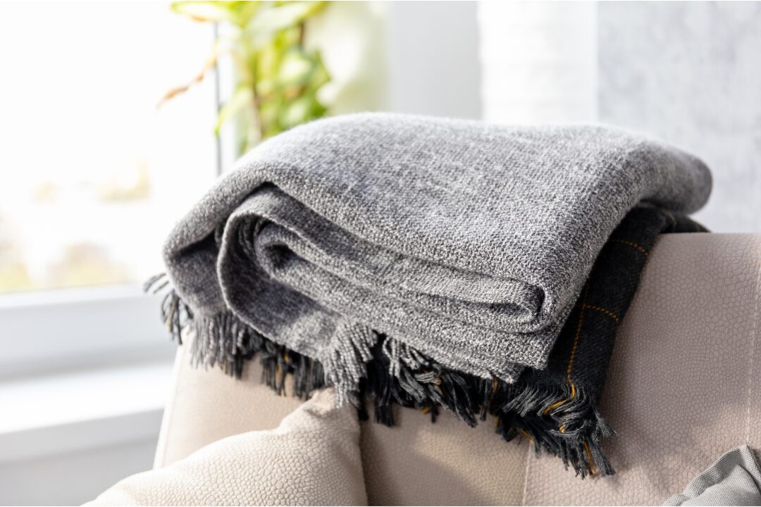 wool blanket folded on the kitchen arm chair 
