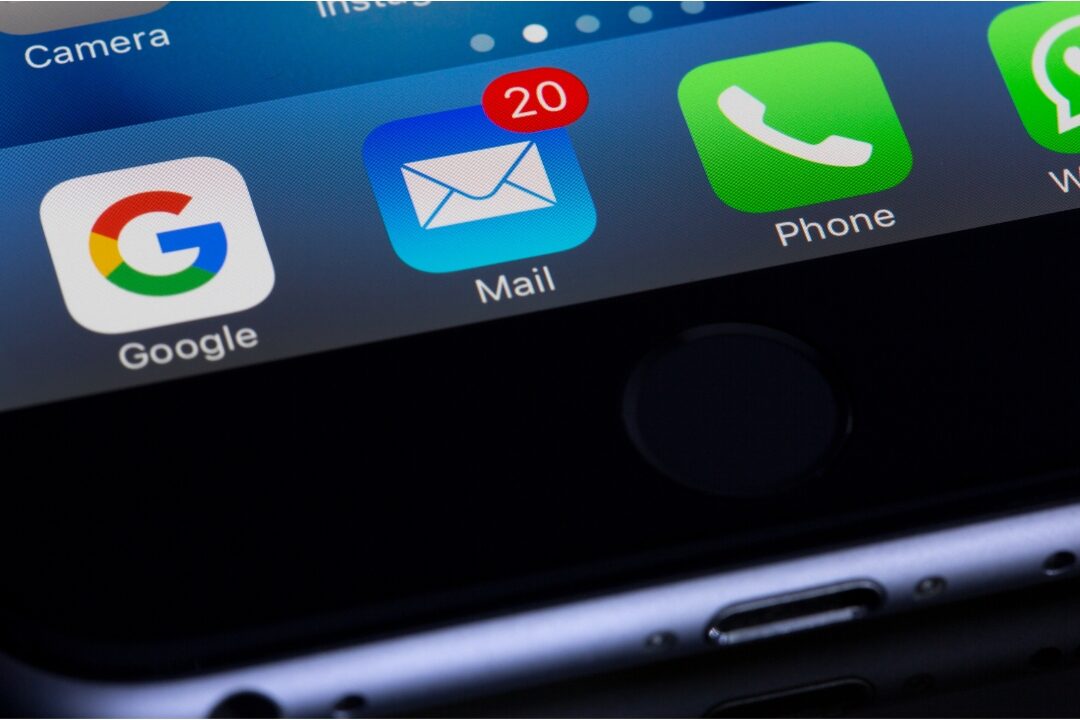 smartphone showing bright notification icons lying on wooden table causing digital fragmentation