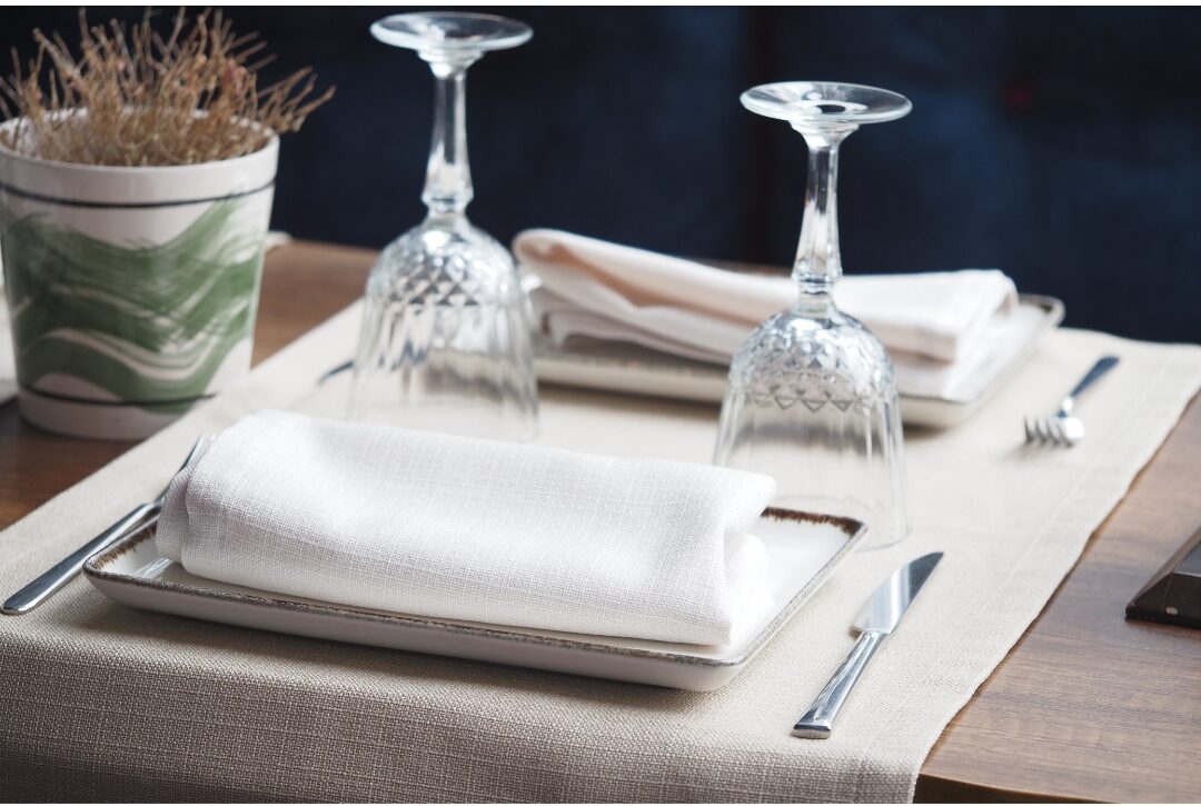 dining table set with simple linen cloth napkins and minimalist plates