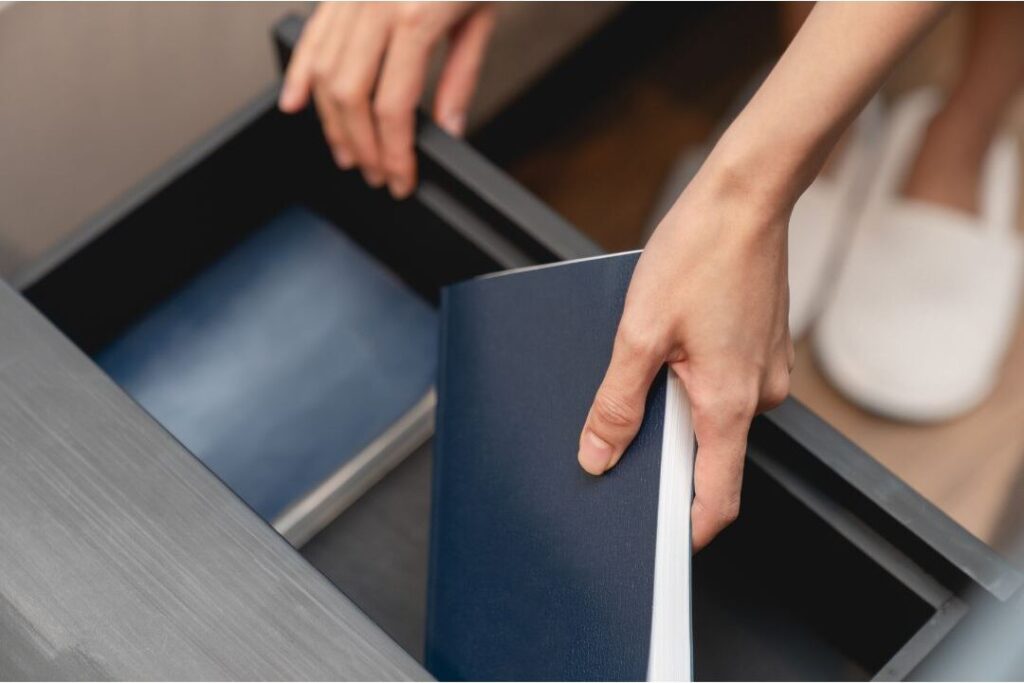 credit card and documents put away in drawer to stop debt dependency