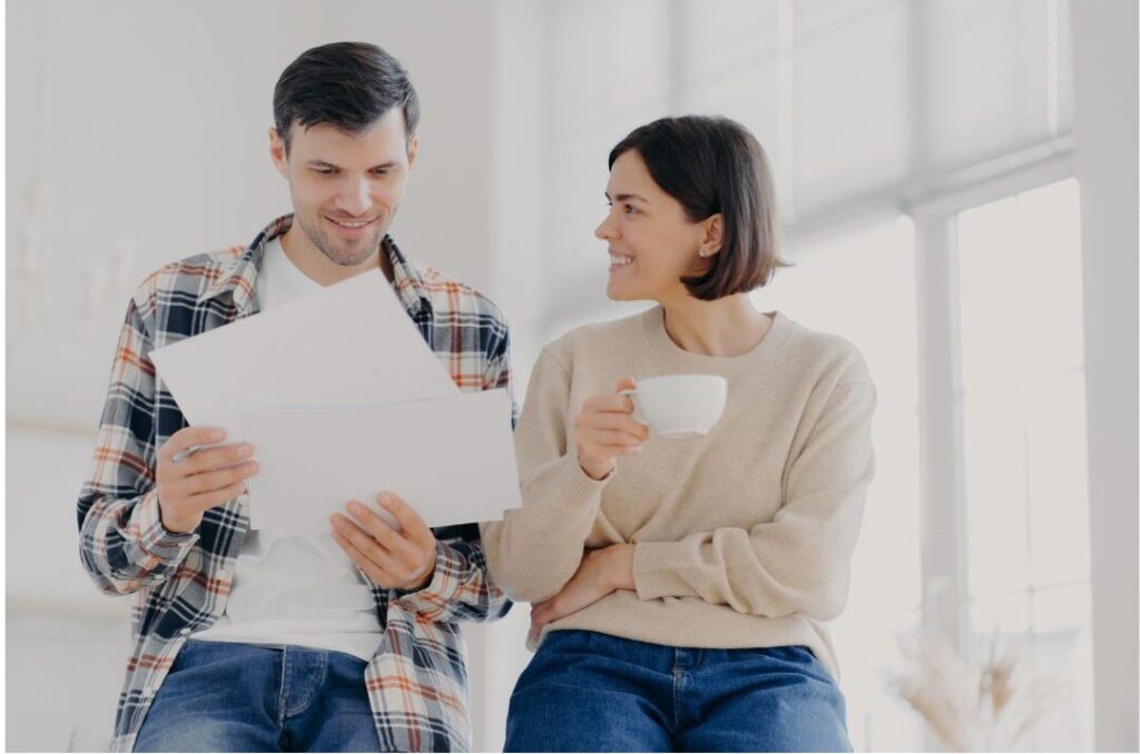 happy couple discussing family budget calmly during money reset