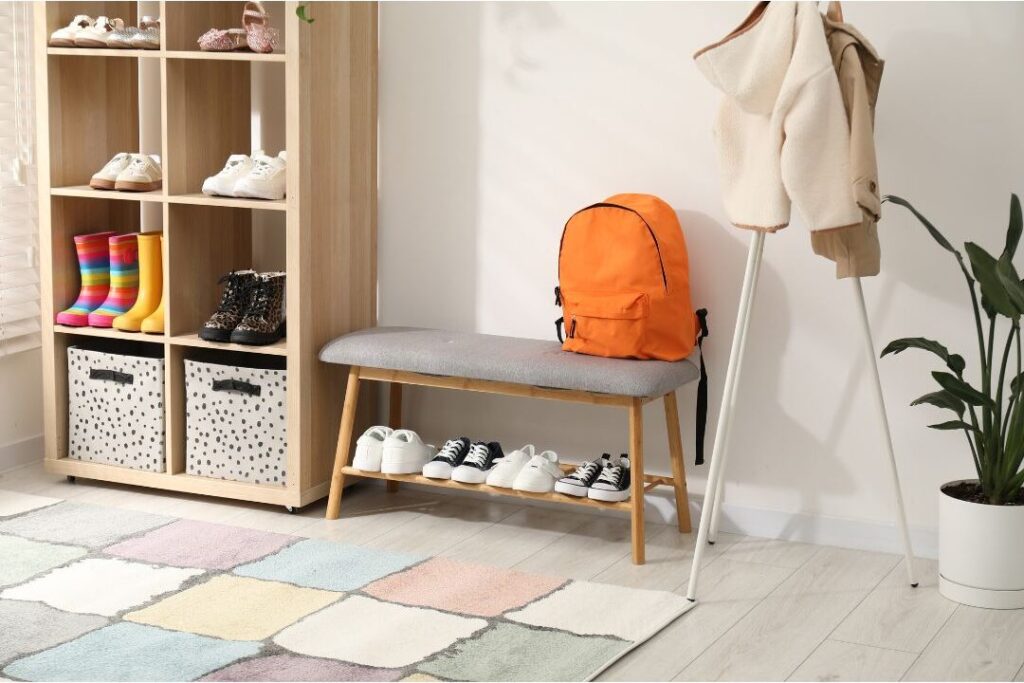 organized wooden entryway bench with backpacks and clean shoes revealing how this one weekly habit eliminated so much stress