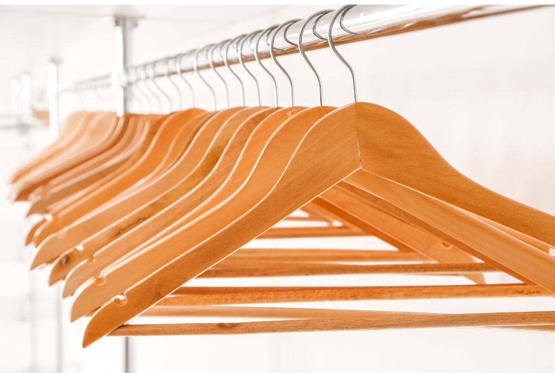 tidy entryway closet with uniform wooden hangers working through 75 things every elegant home has