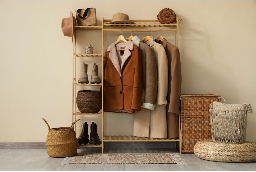 organized entryway coat rack with neatly hung coats simplifying 101 things to declutter this weekend