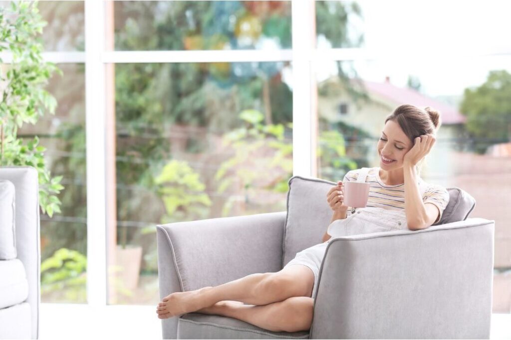 smiling person enjoying coffee reflecting financial peace after 30 day reset