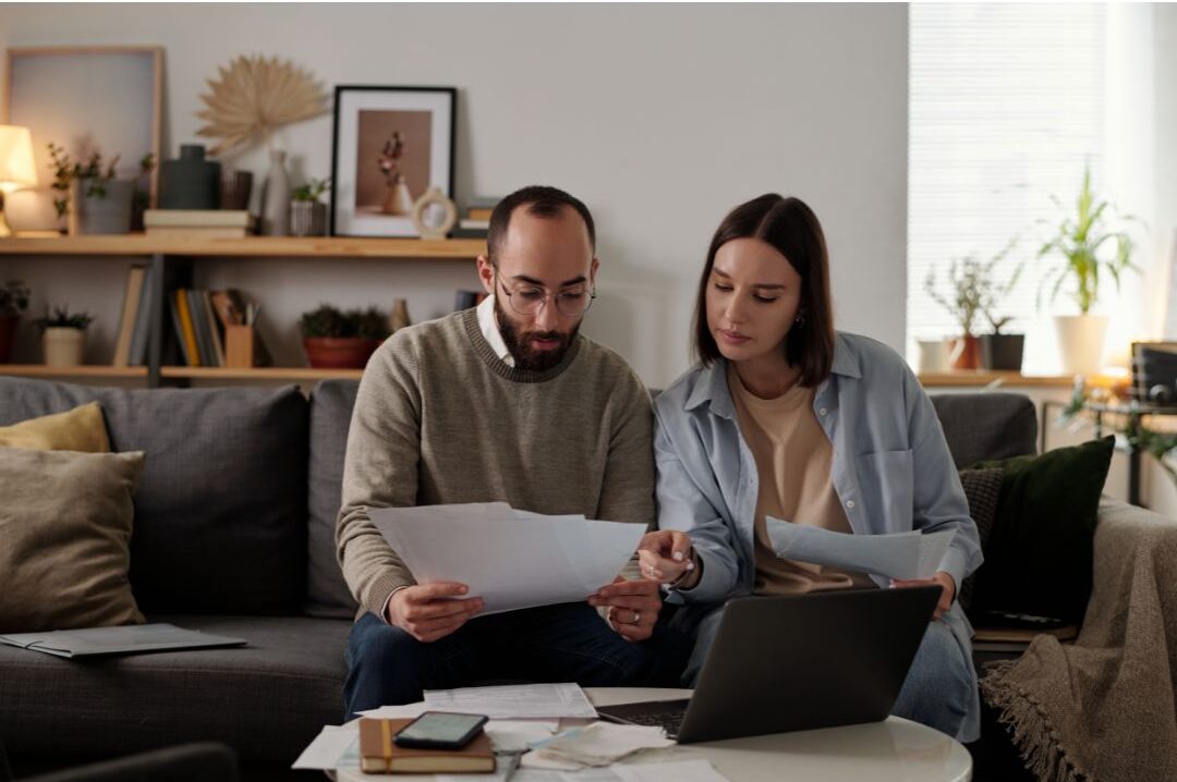 family meeting around dining table reviewing organized financial documents