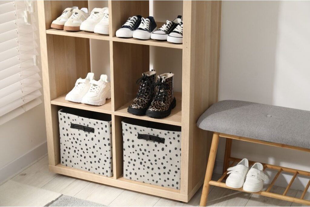shoes placed neatly into wooden entryway cubby