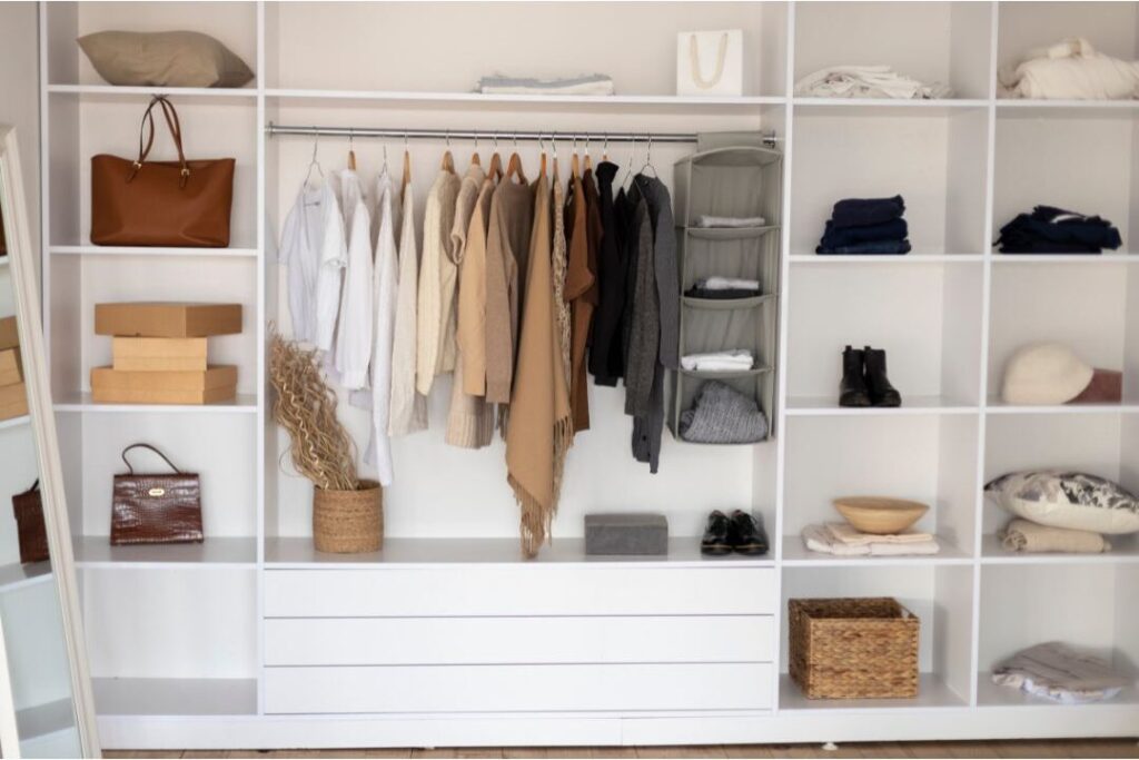 neatly organized clothes hanging in closet arranged by day
