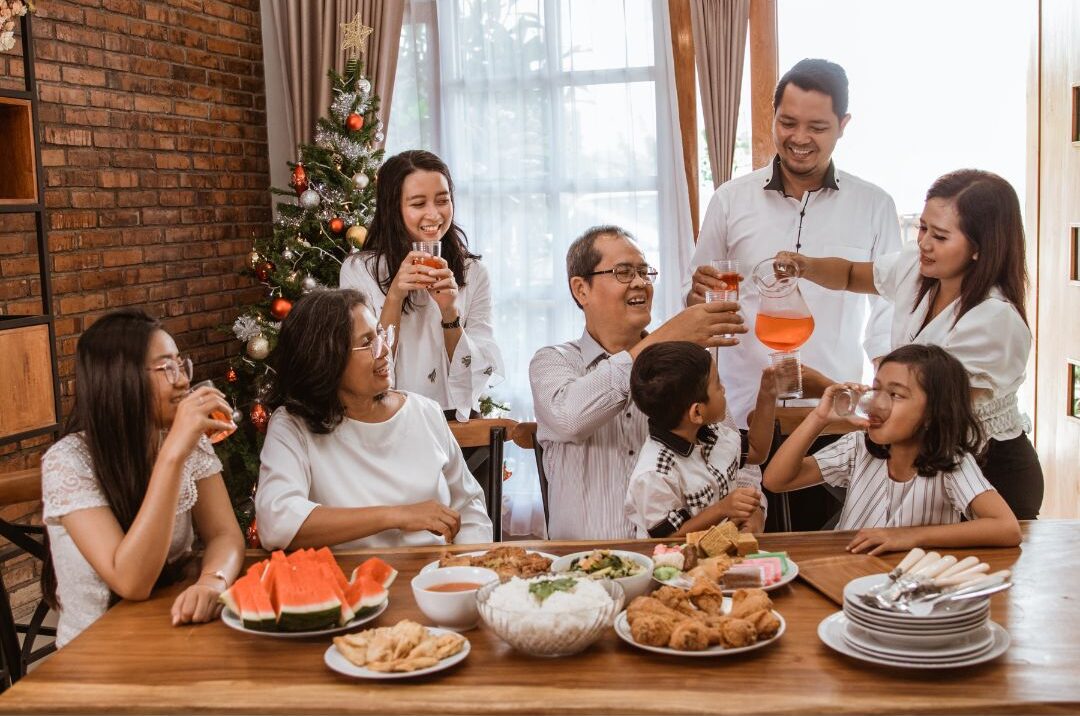 cozy family gathering around wooden dining table laughing together featuring 25 family traditions worth starting