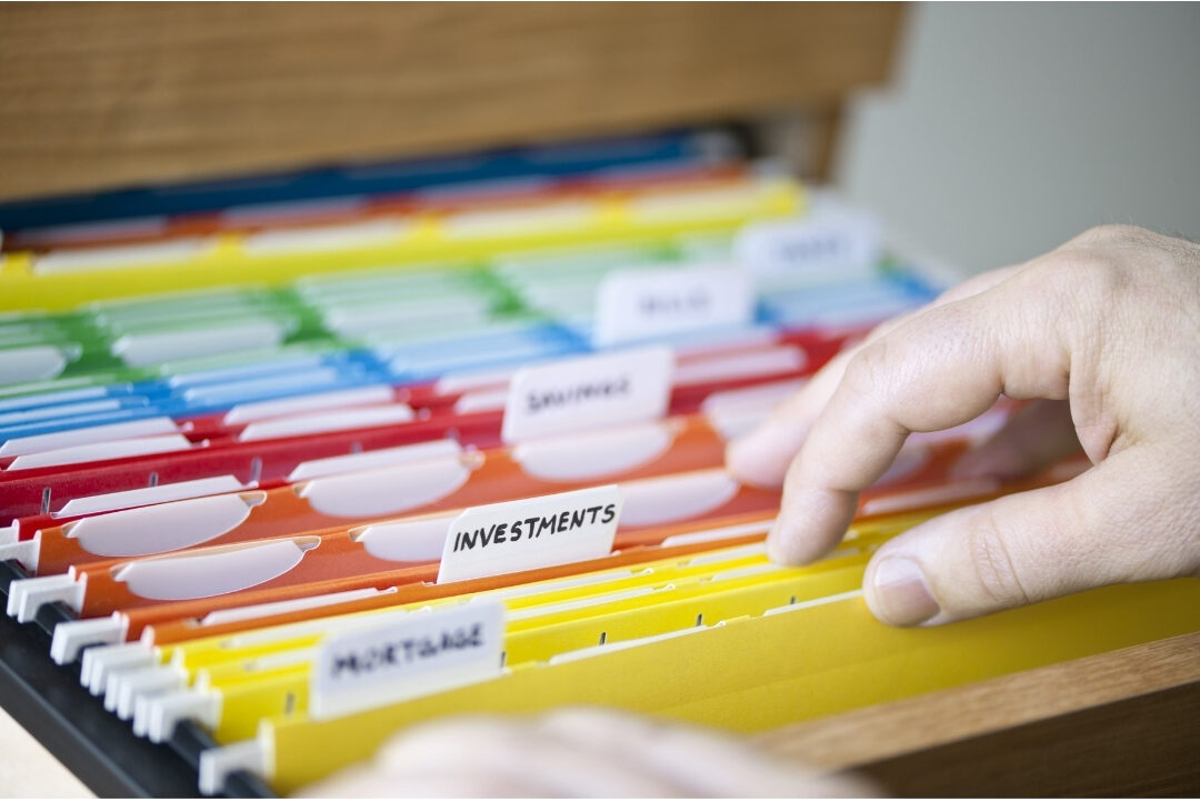 tidy file cabinet drawer with labeled color-coded paper folders