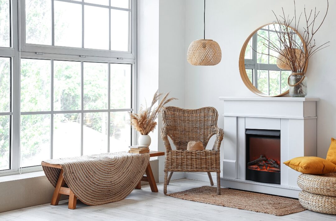 fireplace mantel styled simply with a large mirror and vase of branches