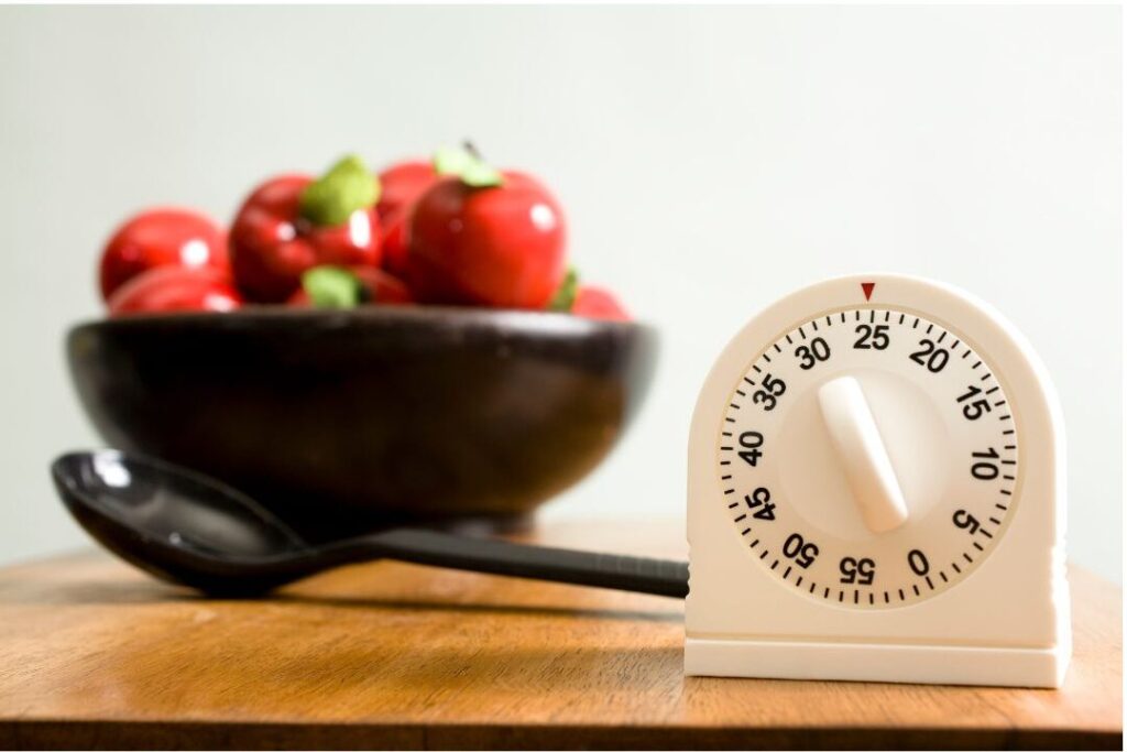 digital timer sitting on wooden kitchen counter counting down
