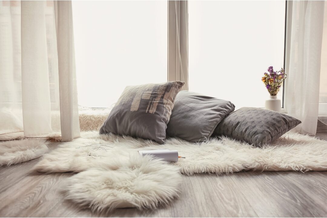 cozy living room floor setup with plush oversized pillows, rugs, and blankets