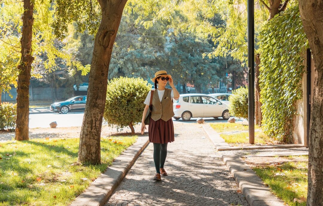 woman walking confidently along sunlit suburban path discovering things mentally strong moms do differently