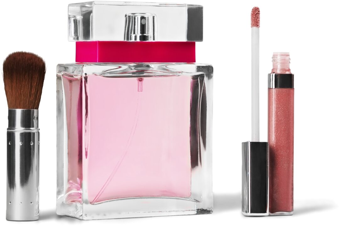 clear glass fragrance bottle sitting near clean makeup brushes