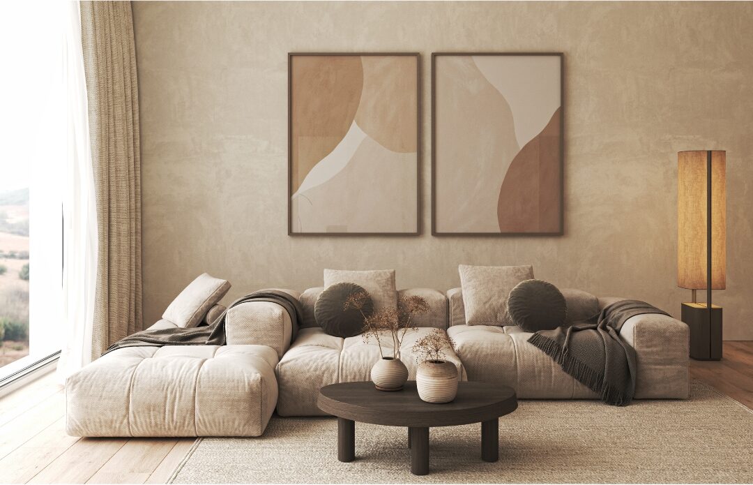 framed abstract art prints hung symmetrically above a neutral sofa