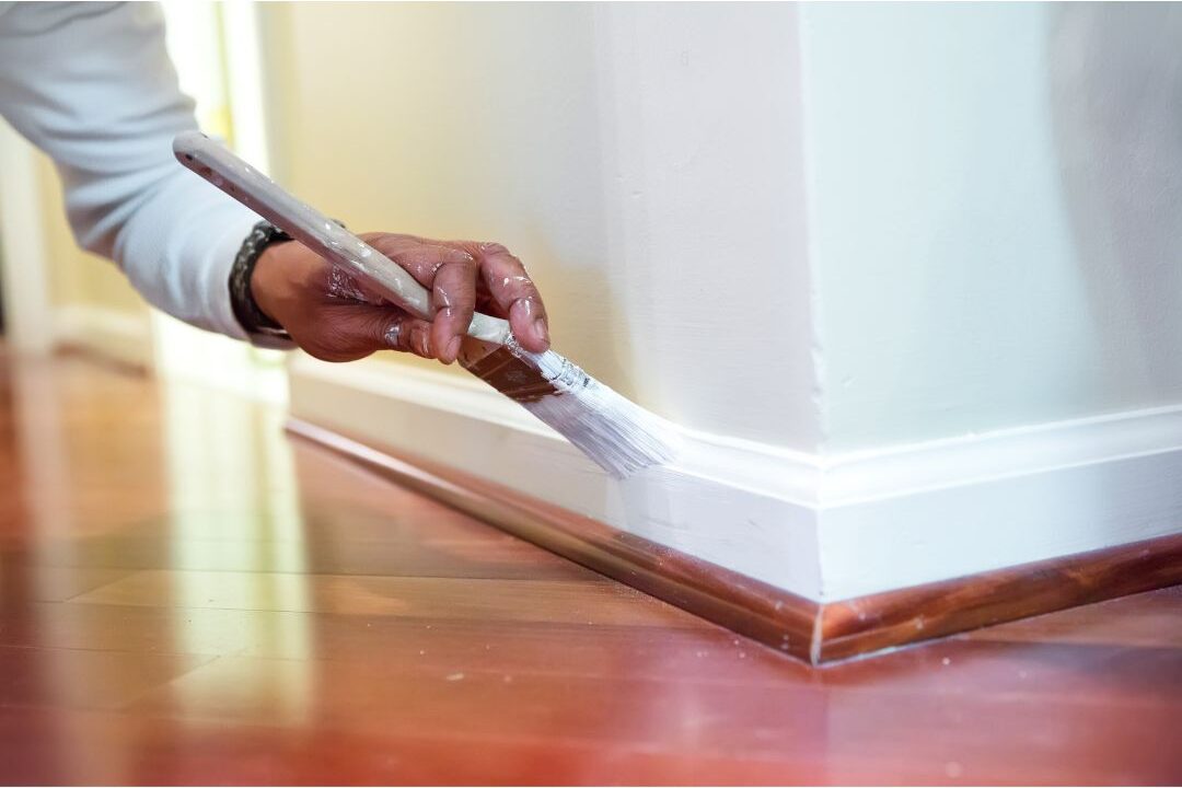 crisp white baseboards painted neatly against dark oak floor presenting 70 budget-friendly home upgrades that are actually worth it