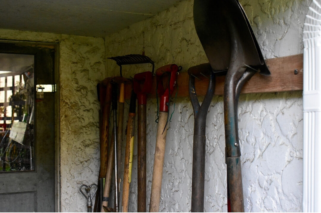 organized garden shed corner with neatly hung shovels finishing 101 things to declutter this weekend