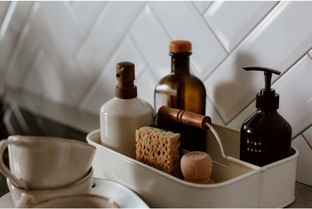 clean glass shower enclosure with neatly arranged minimalist soap bottles