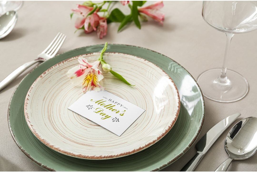 ceramic dinner plate with hand painted gratitude words sitting on decorated table