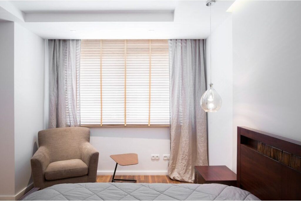 clean bedroom accent chair without clothes sitting quietly in corner