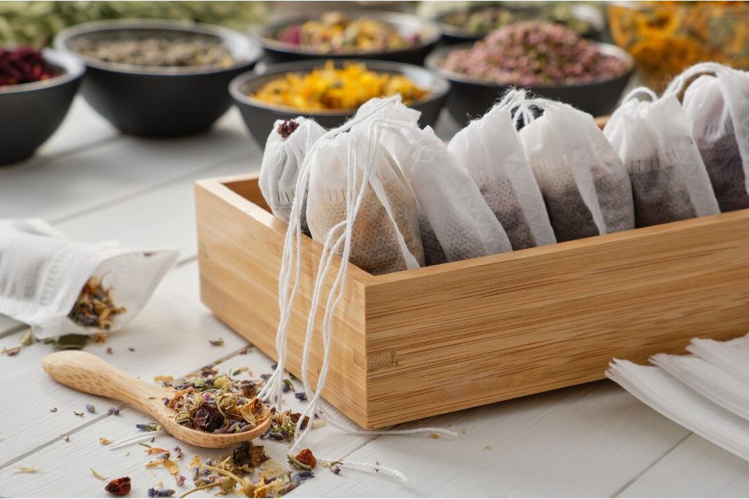 assorted herbal tea bags arranged neatly in wooden box organizer