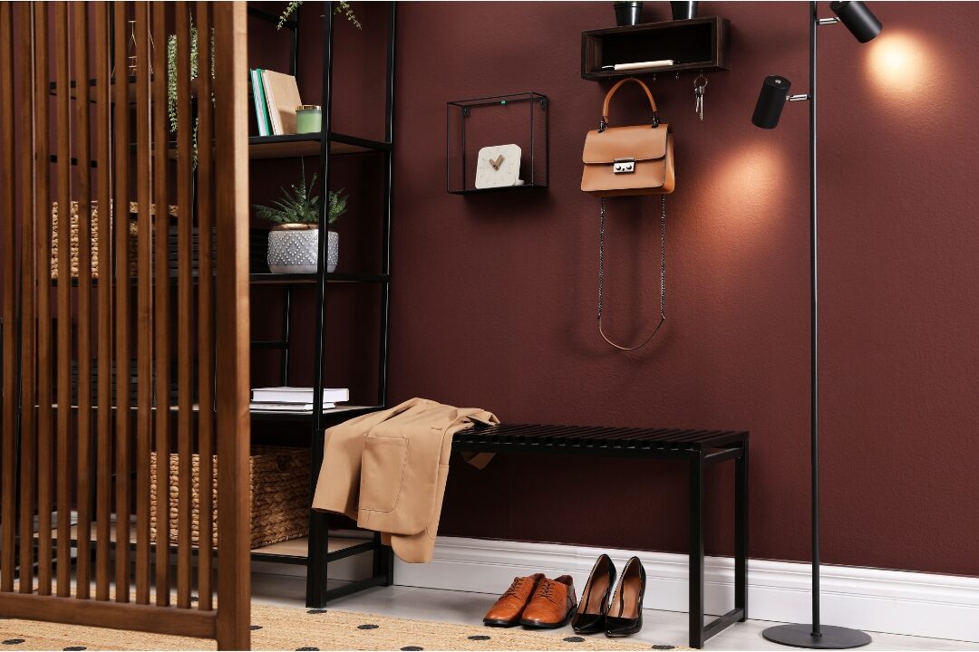 neatly organized entryway with coat hooks and shoe bench creating low-friction routines