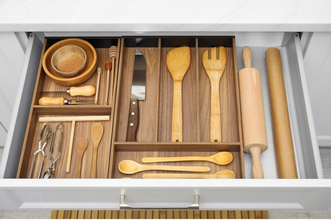 clean kitchen drawer with wooden utensil dividers holding essential cooking items