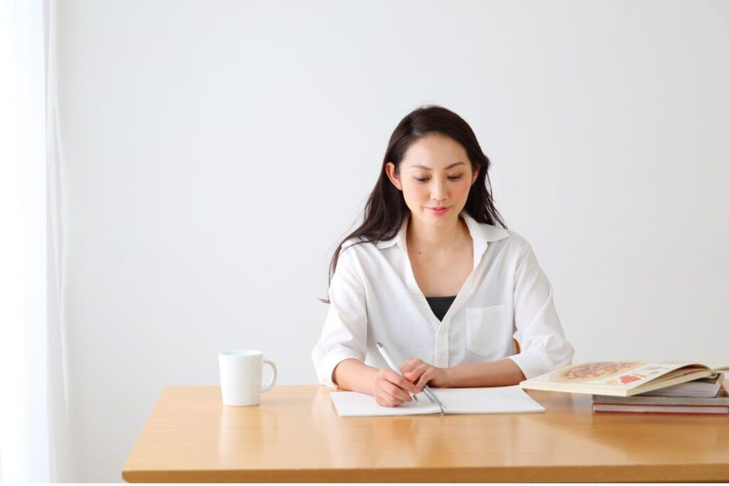 person reflecting thoughtfully at kitchen table about lessons learned