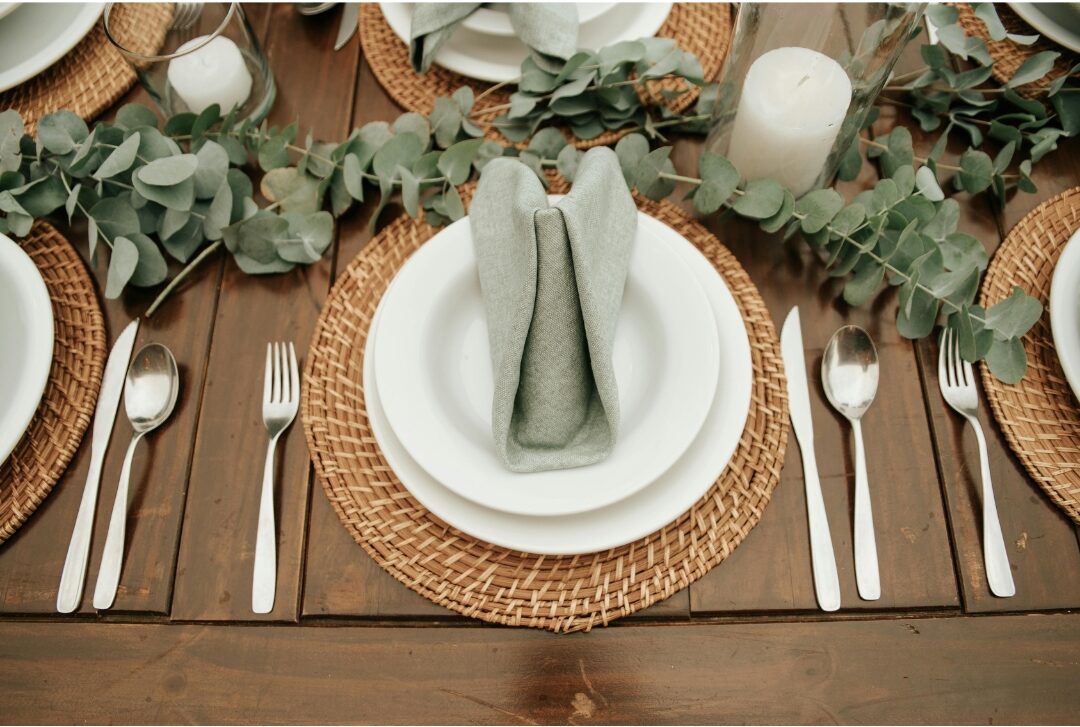 neutral linen cloth napkin folded neatly on ceramic dinner plate presenting 30 tiny luxuries every woman deserves