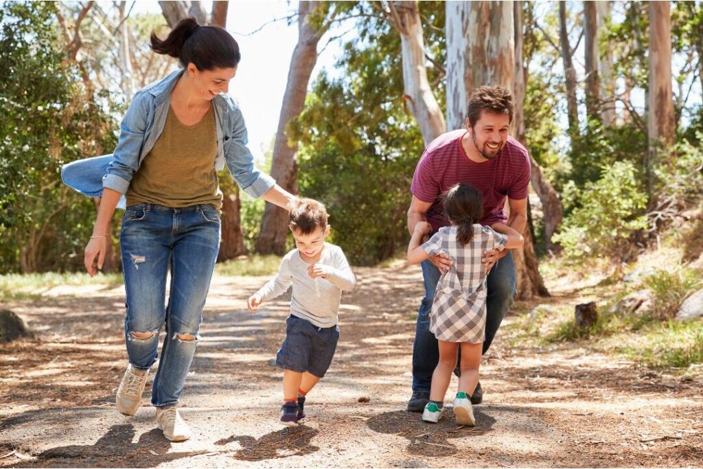family walking together outdoors demonstrating low cost frugal family activities