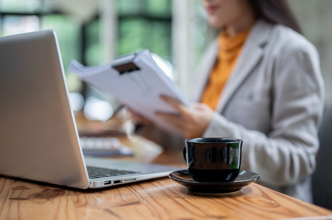woman reviewing financial planner calmly with cup of tea taking control of finances