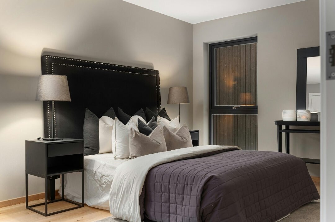 minimalist bedroom nightstand with a ceramic lamp and clean surface
