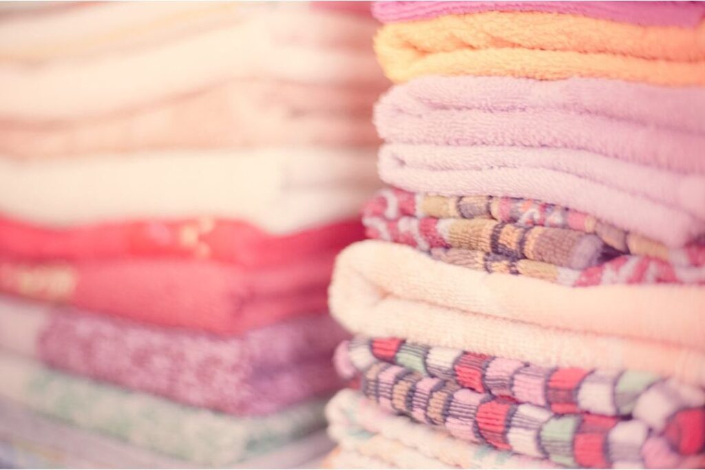 neatly folded kids capsule wardrobe showing smart spending for families