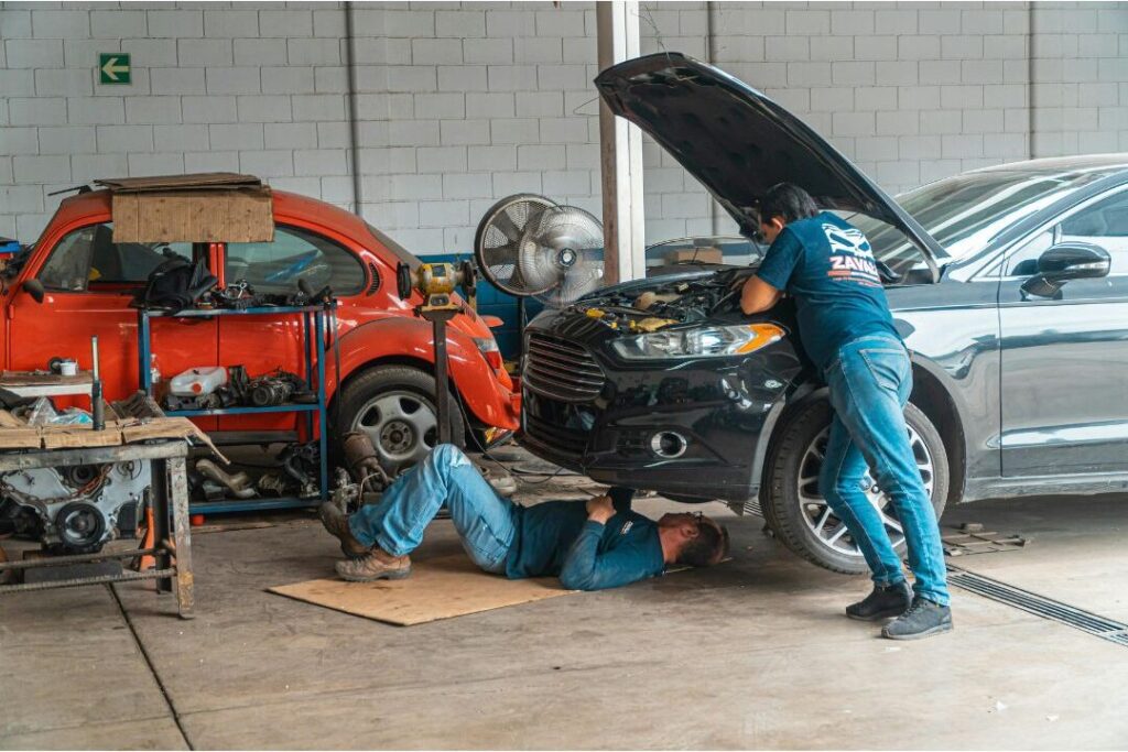 car engine repair demonstrating unexpected minor expenses that derail budgets