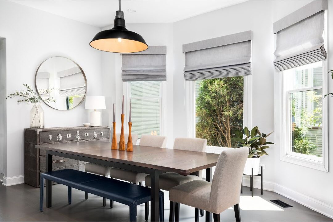 modern brass pendant light hanging above dining table showcasing 70 budget-friendly home upgrades that are actually worth it