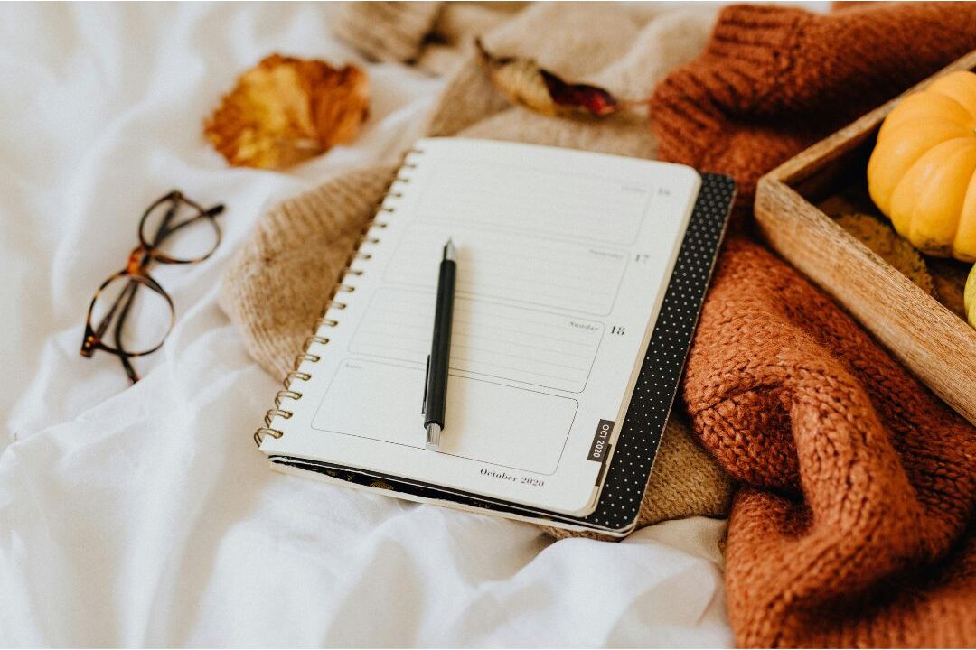 open journal with pen on soft beige linen blanket showcasing 45 daily habits that make life easier