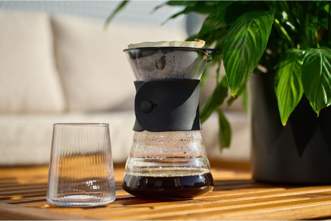 glass water carafe with matching glass resting on wooden nightstand