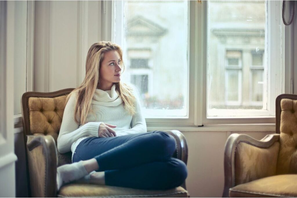 woman resting peacefully in chair representing non-material stress relief for moms