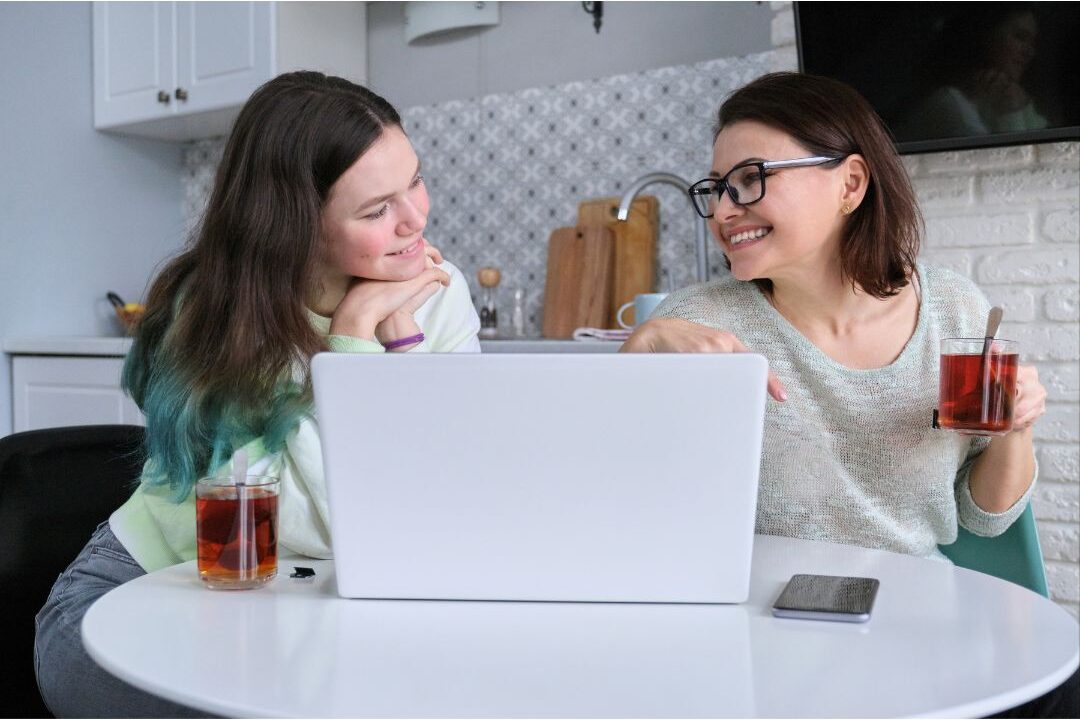 parent having an open encouraging chat with teenage daughter at kitchen counter