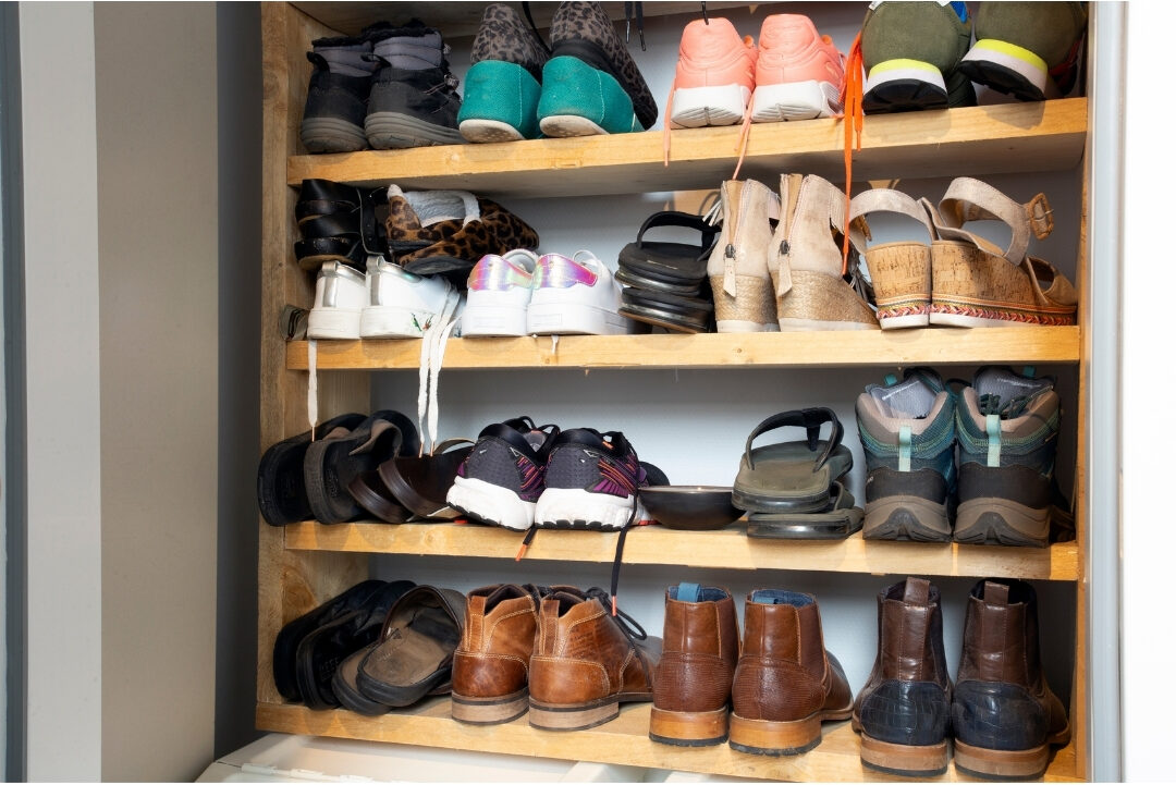 neatly arranged shoe rack in a sunlit bedroom closet corner