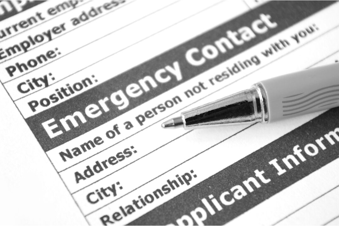 framed emergency contact list hanging neatly near wall telephone maintaining family safety reference