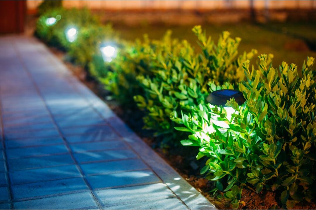 warm solar stake lights illuminating stone garden walkway at night