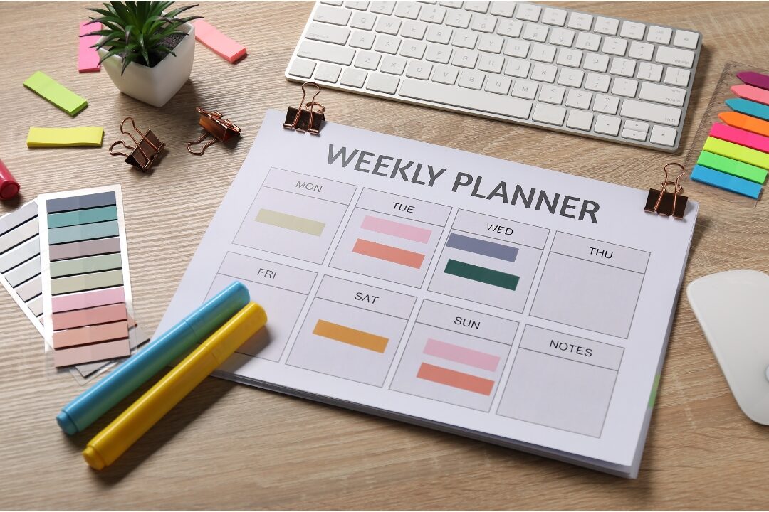 clean weekly planner sitting open on warm wooden desk seeing that you're not lazy you're probably overloaded